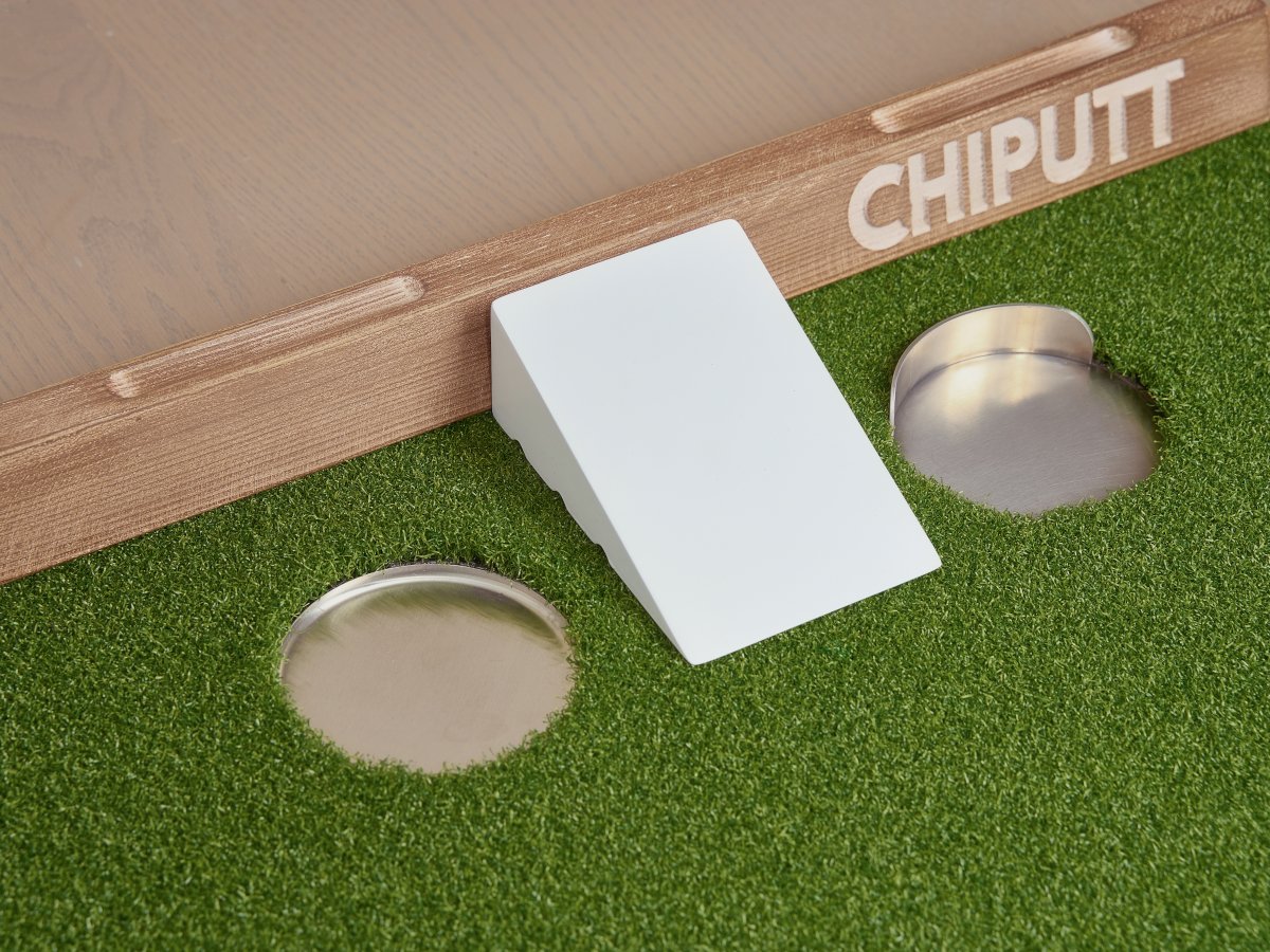 Chiputt putting mat complete accessory showcase featuring hole cups with back lip, without back lip, PaceMaster, and wooden backstop