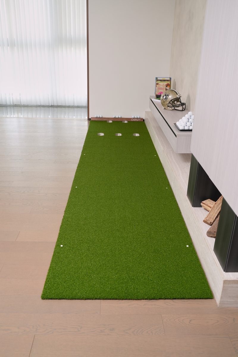 Vertical view of the Chiputt 3 ft × 11 ft putting mat with the 2.5 ft long Dual-Hole Chipping Mat connecting to the back — total putting distance 13.5 ft, 5-hole system (3 holes on the putting mat, 2 holes at the back on the chipping mat) enabling games like HORSE and extended putting drills