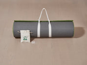 This image displays the contents of the Chiputt Extender box for the 3-foot width options. It includes the extender mat with mat strap, two sets of white distance markers, and one accessory pouch. The Extender connects and extends the main Chiputt mat, providing more practice distance for putting and short game drills.