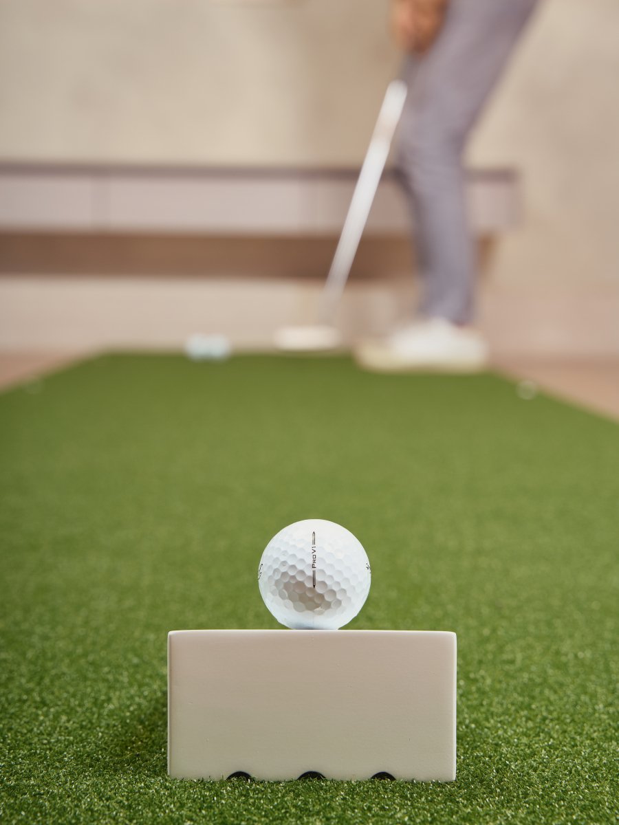 Chiputt putting mat PaceMaster showing perfect pace with Titleist Pro V1 golf ball at top of ramp demonstrating ideal speed control