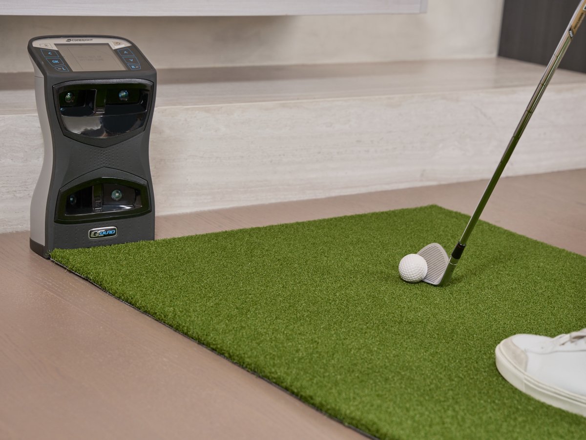Golfer chipping a soft foam golf ball on Chiputt’s complimentary step-on mat with a Foresight GCQuad launch monitor analyzing spin and distance, illustrating indoor practice versatility.